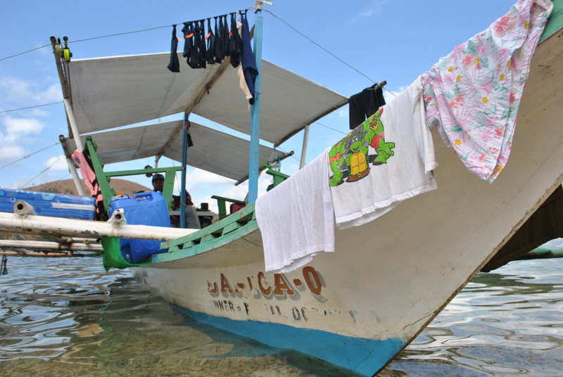 a bangka fishing boat ashore in Palawan, Philippines, with my laundry hanging on it