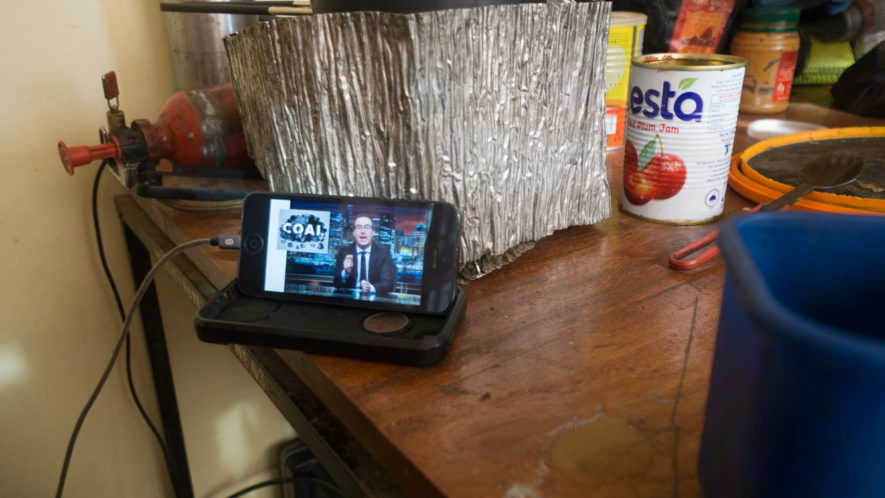 John Oliver video playing on iphone on the table of a Tanzanian guesthouse