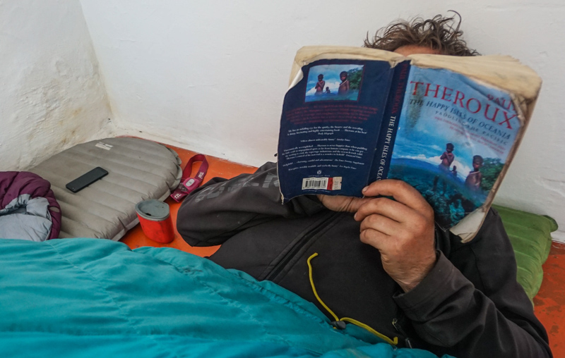 evan on his air mattress reading happy isles of oceania by paul theroux