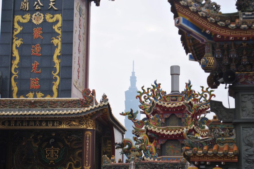 Taipei 101 in the background, ornate roofs of religious temples in the foreground
