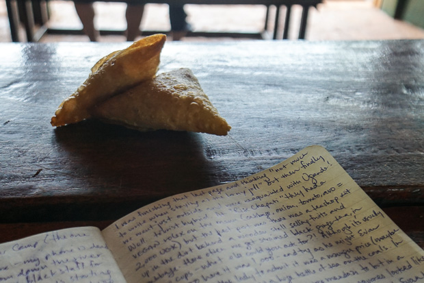 two small chickpea samosas sitting beside my open journal